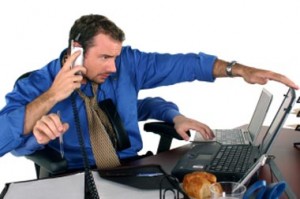 Photo illustration shows man with four arms working telephone and 2 laptops simultaneously.<BR>©   Julie de Leseleuc, iStockphoto” title=”Multitasker 380×253″ width=”300″ height=”199″ class=”size-medium wp-image-2778″ /></a><p class=