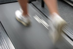 Closeup of running man using treadmill.